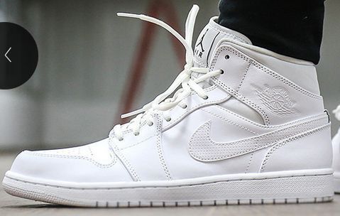 Lifestyle image showing a white high-top sneaker being worn, with the Swoosh and Jordan Wings emblem visible.
