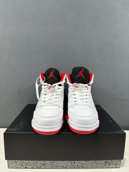 Front view of the pair showing white toe boxes, white laces, black tongues, and red tongue logos.