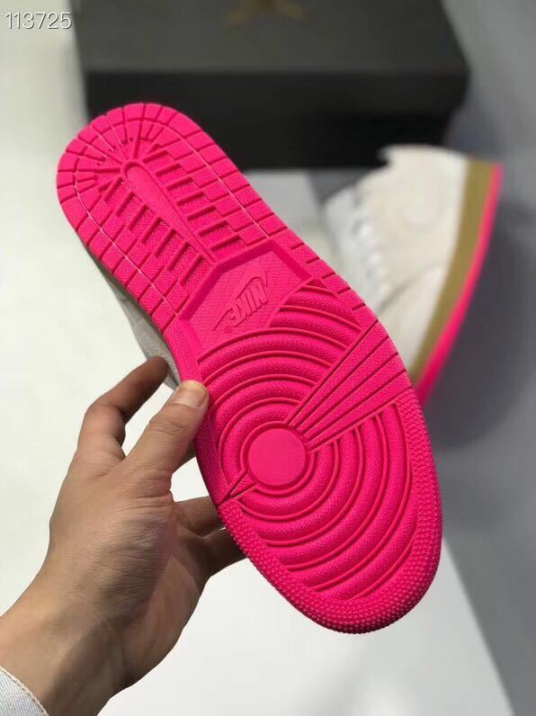 Close view of the bright pink rubber outsole with circular and linear tread patterns.