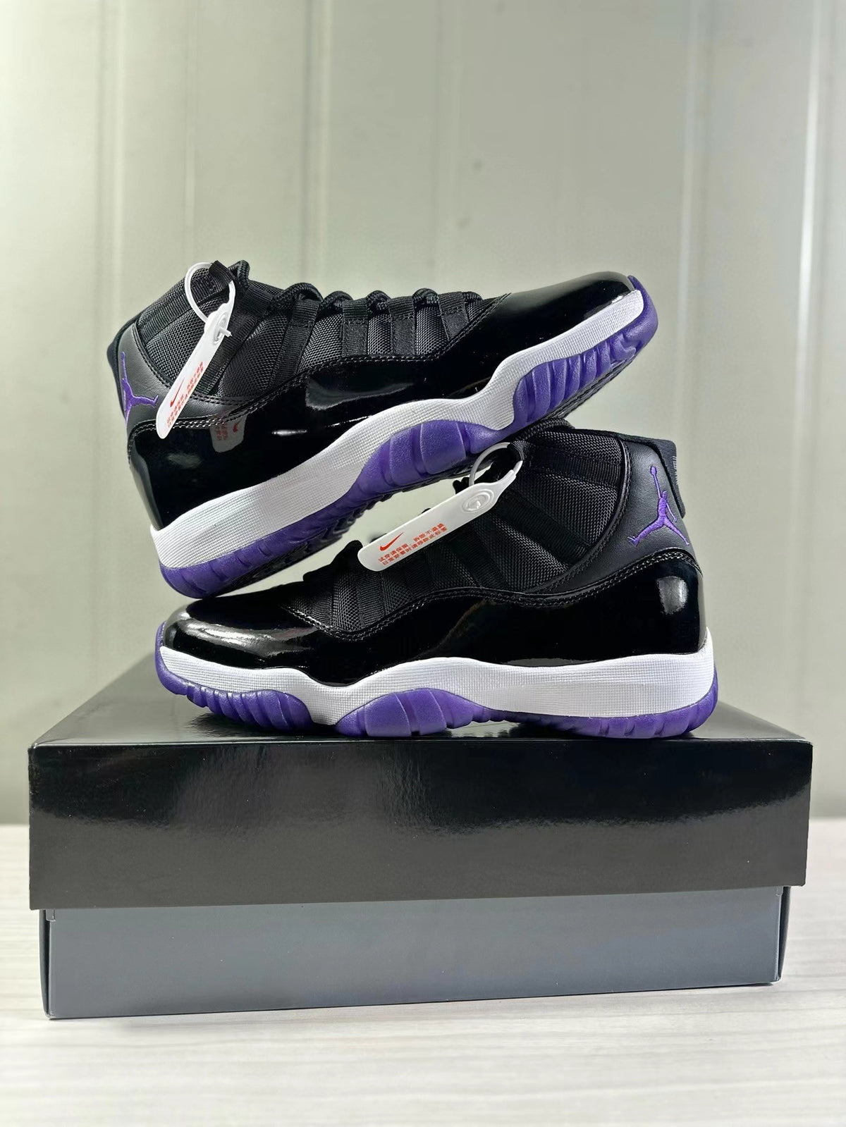 Stacked product view showing both sides of the black and purple sneaker pair.
