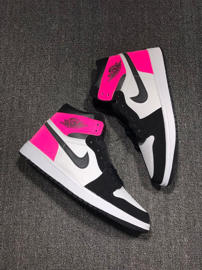 Pair of pink, black, and white high-top sneakers arranged diagonally on a textured surface.