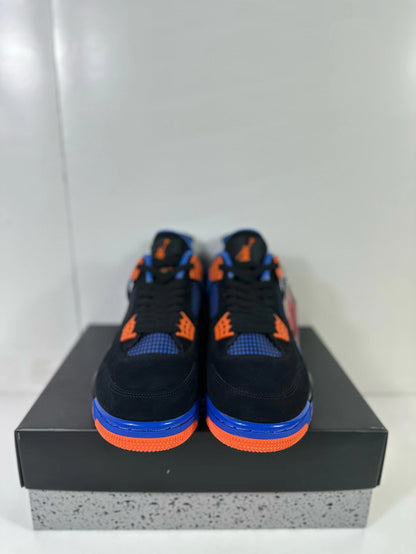 Front view of the pair showing black uppers, blue mesh panels and orange lace hardware.
