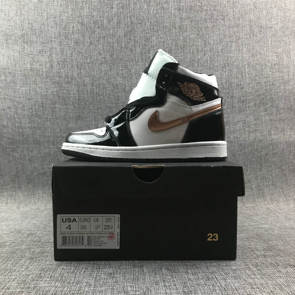 Side-profile product photo with the sneaker positioned on a black shoebox; box label shows USA 4 and EURO 36.