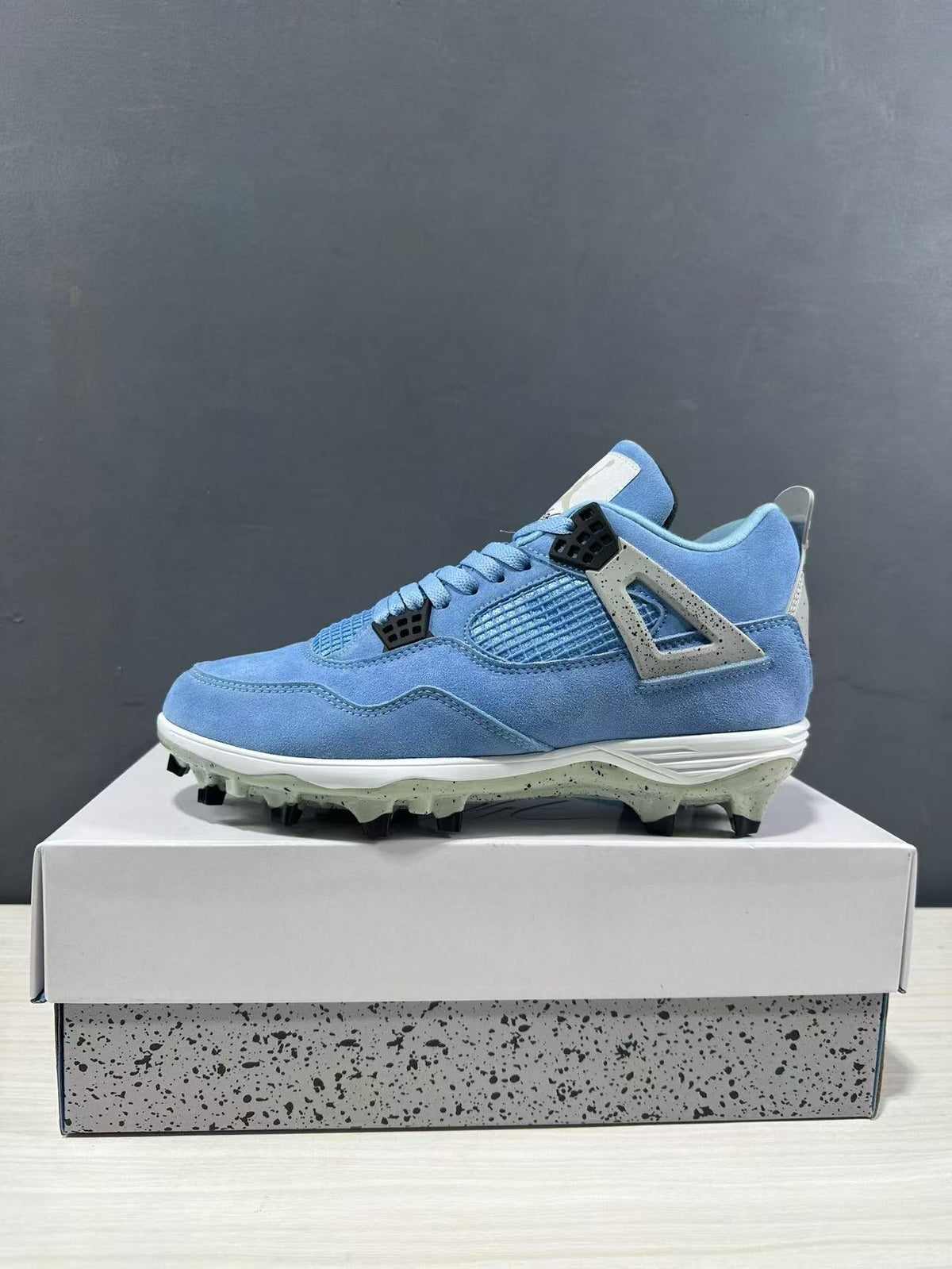 Side profile of one University Blue sneaker with its lace closure, mesh panel, and white midsole.