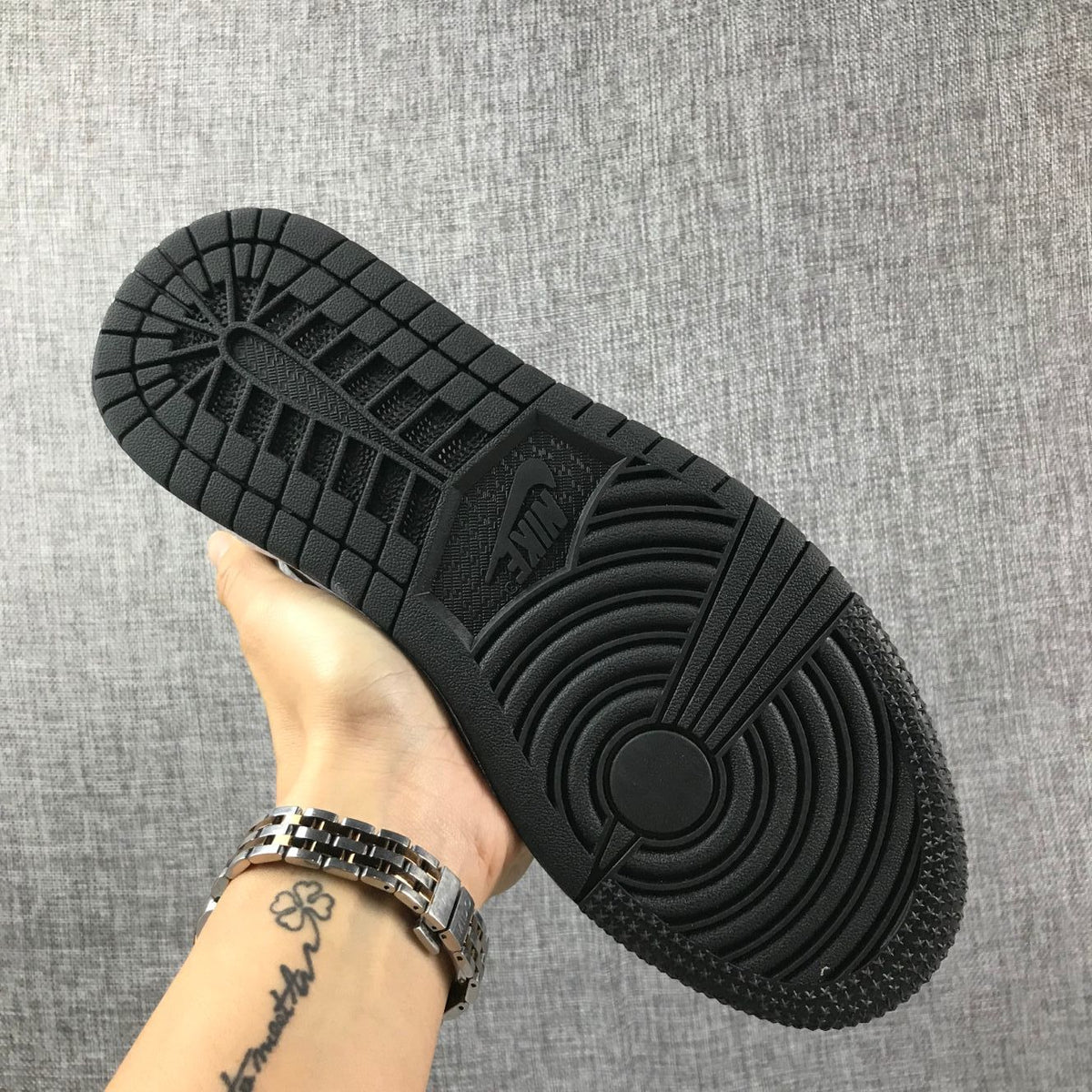 View of the black rubber outsole with circular and segmented traction patterns.