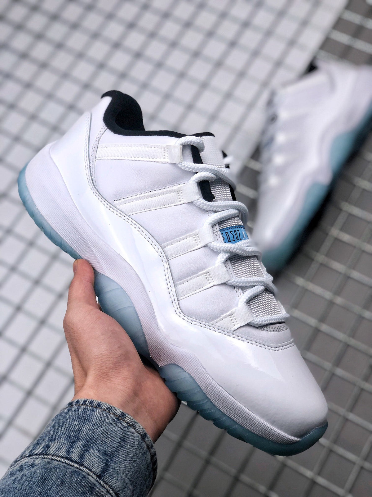 Angled side view highlighting the white upper, layered side panels, and translucent blue outsole.
