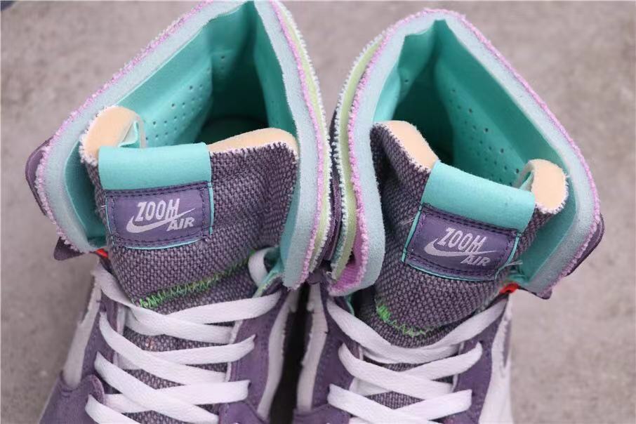 Top-down close-up showing the padded tongues, Zoom Air labels, teal lining and white laces.