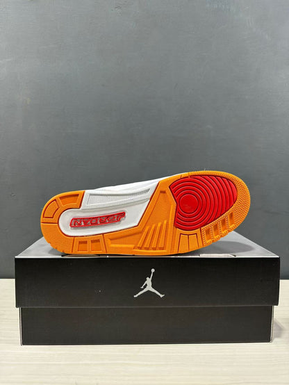 Outsole view showing the orange rubber tread, red circular forefoot traction area and Jordan branding.