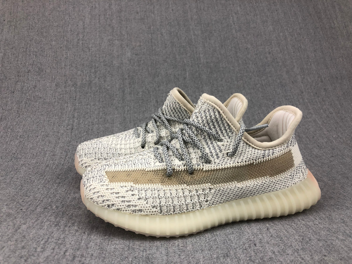 Angled pair view of the cream-white and gray knitted sneakers.