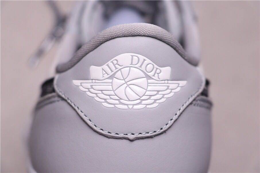 Close-up of the grey heel panel with an Air Dior winged basketball emblem.