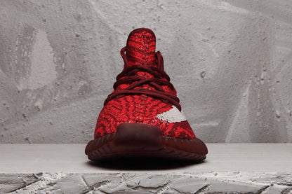 Front view showing the red knit-style upper, laces, and contrasting white side stripe.