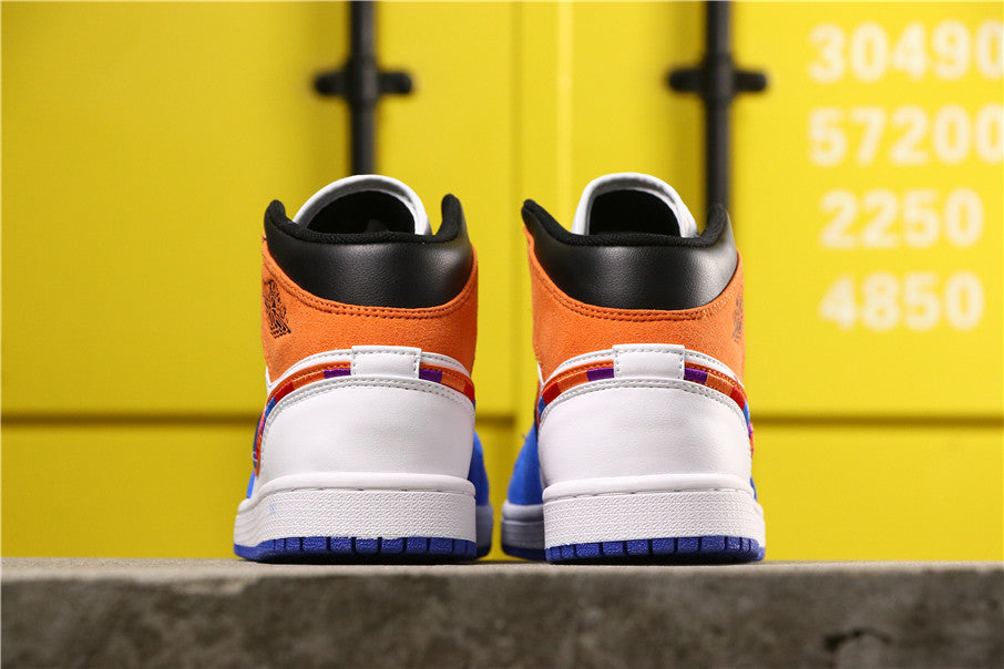 Rear view showing the orange heel panels, black collars, white heel sections and blue outsoles.