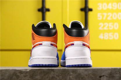 Rear view showing the orange heel panels, black collars, white heel sections and blue outsoles.