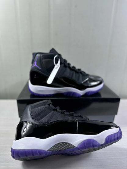 Close angled view of the glossy black upper, white midsole, purple outsole, and visible traction area.