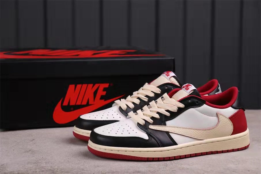 Pair of black, white, red, and cream low-top sneakers displayed with a branded black shoebox.