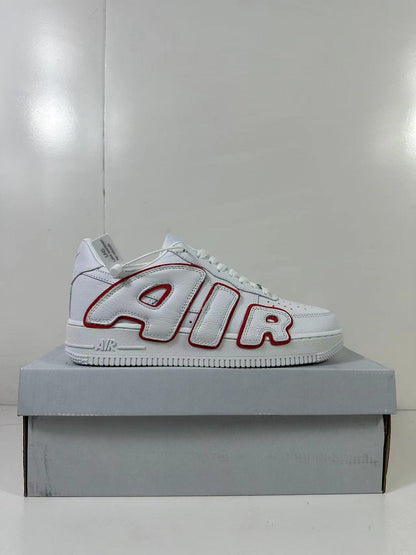 Side profile of the white low-top sneaker with red-outlined AIR lettering and a white platform-style sole.