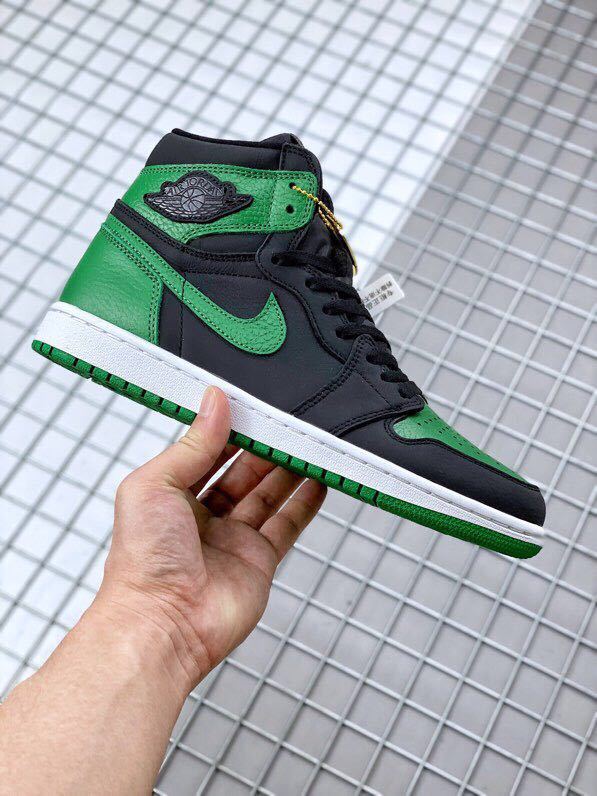 Side view highlighting the green collar, black panels, white midsole, and green outsole.