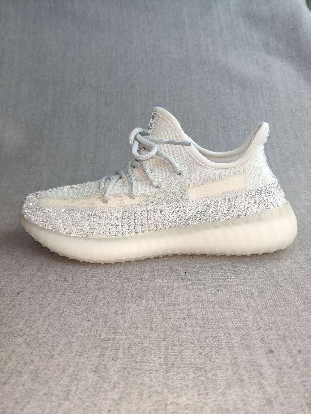 Side profile highlighting the white upper, silver reflective-looking stripe, and translucent sole.
