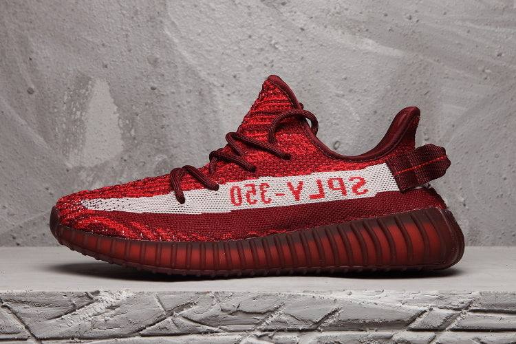 Side profile showing the burgundy upper, white stripe, heel pull tab, and ribbed sole.
