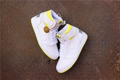 Overhead view of the paired white and yellow sneakers with a round hanging tag.