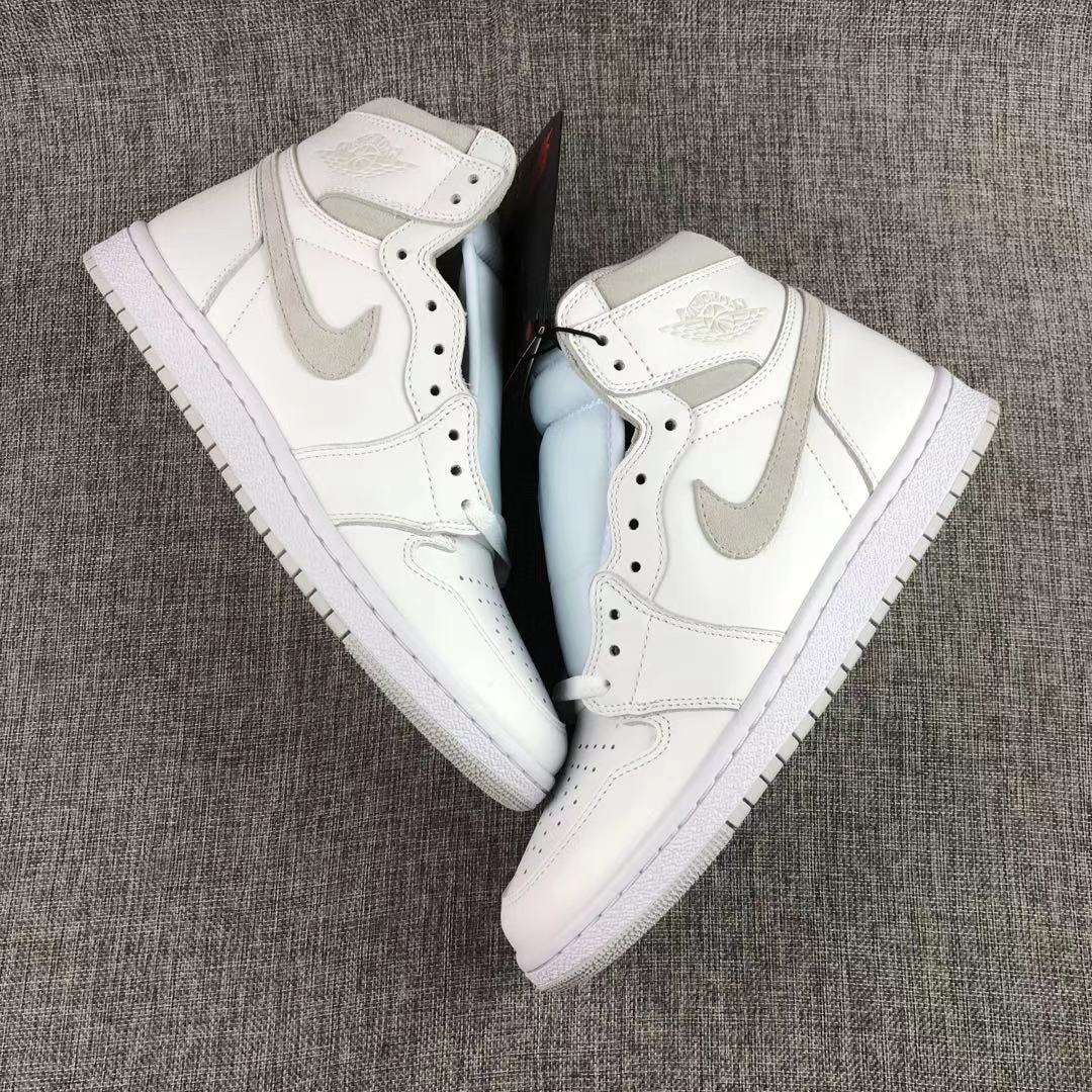 Pair of white and grey high-top sneakers arranged side by side.