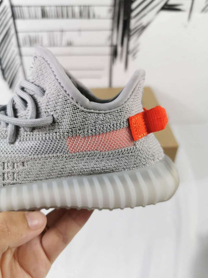 Close-up of the orange heel pull tab and pink side stripe.