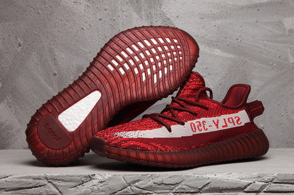 Burgundy and red Yeezy 350 V2-style sneakers shown from the side and outsole views.