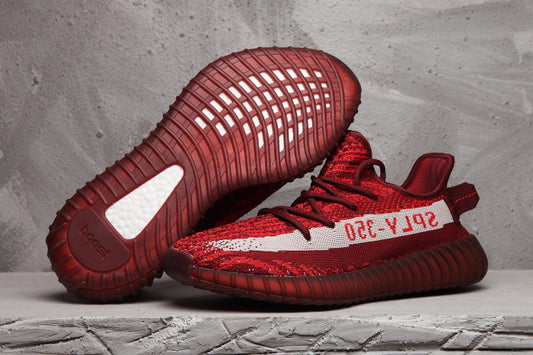 Burgundy and red Yeezy 350 V2-style sneakers shown from the side and outsole views.