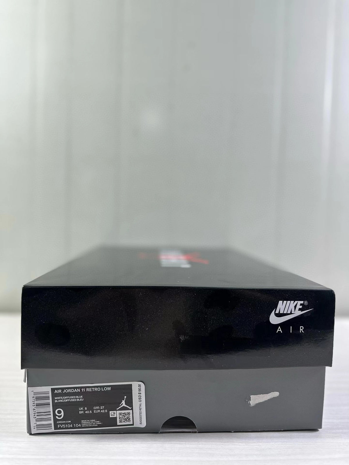 Shoebox label identifying Air Jordan 11 Retro Low, White/Diffused Blue, and size 9