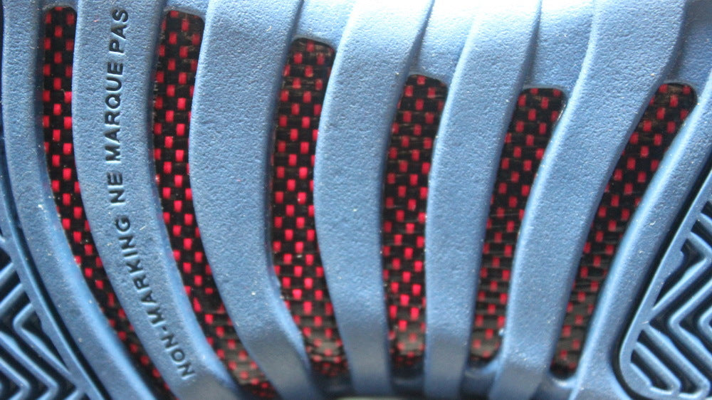 Close-up of the patterned outsole with red and black sections.