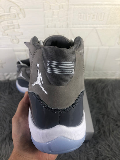 Rear view showing the grey heel panel, embroidered Jordan branding, dark overlay, and translucent outsole.