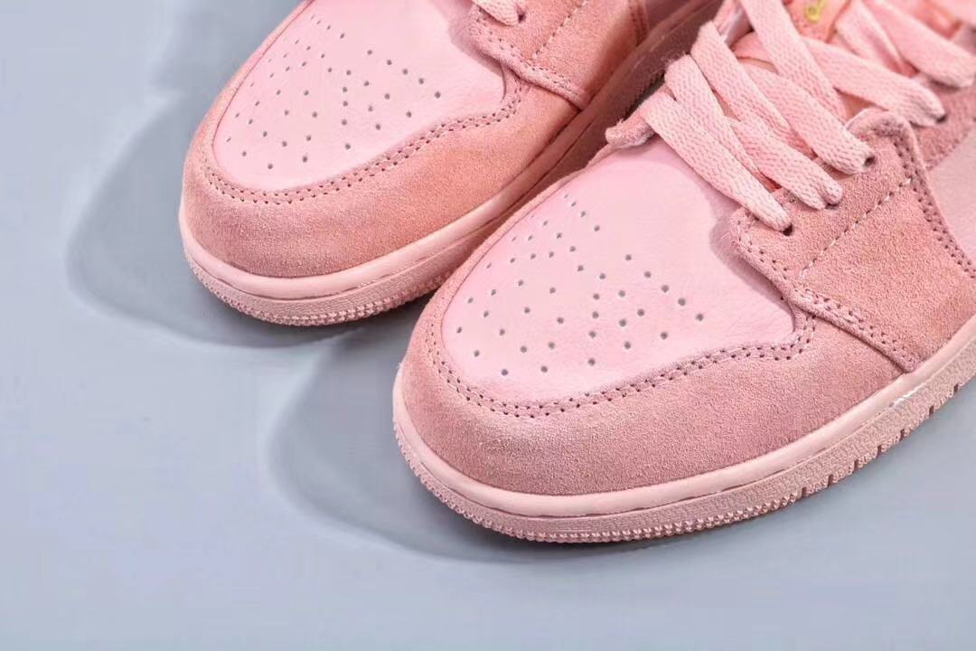 Close-up of the perforated pink toe boxes and textured toe overlays.