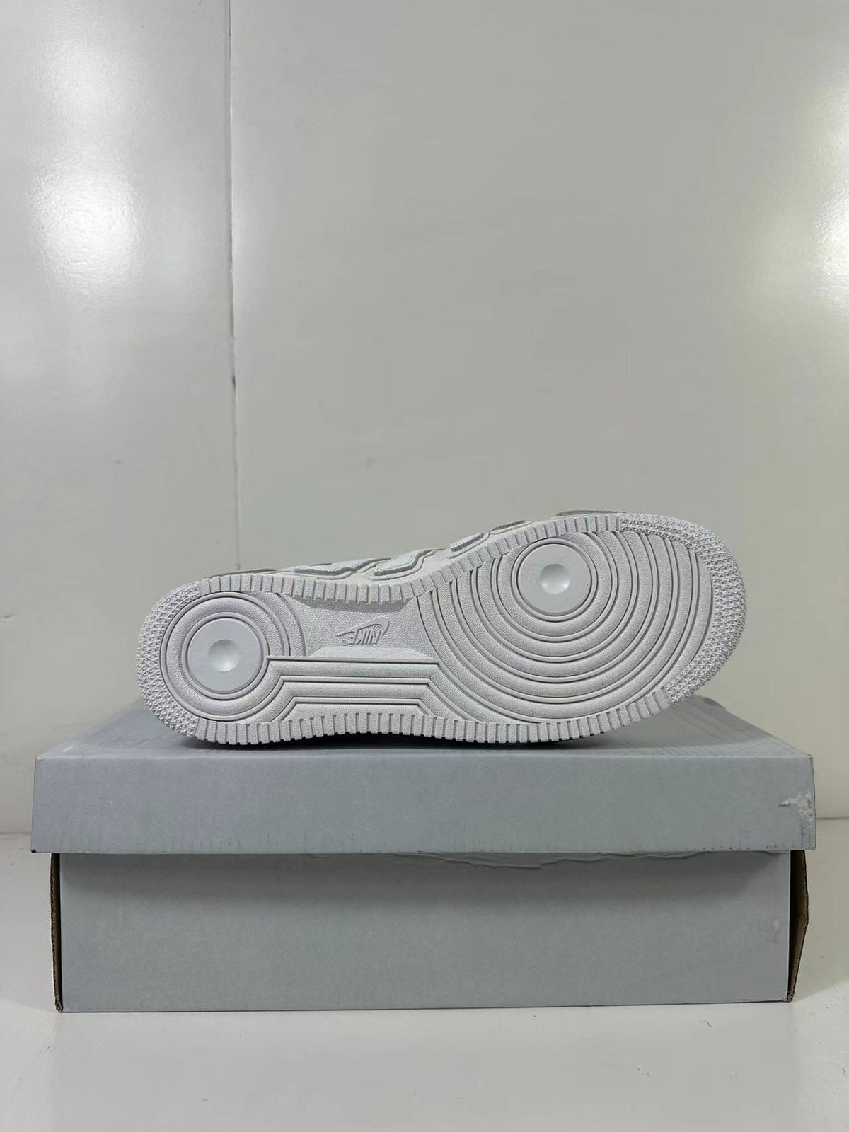 Underside view showing the circular traction pattern on the white rubber outsole.