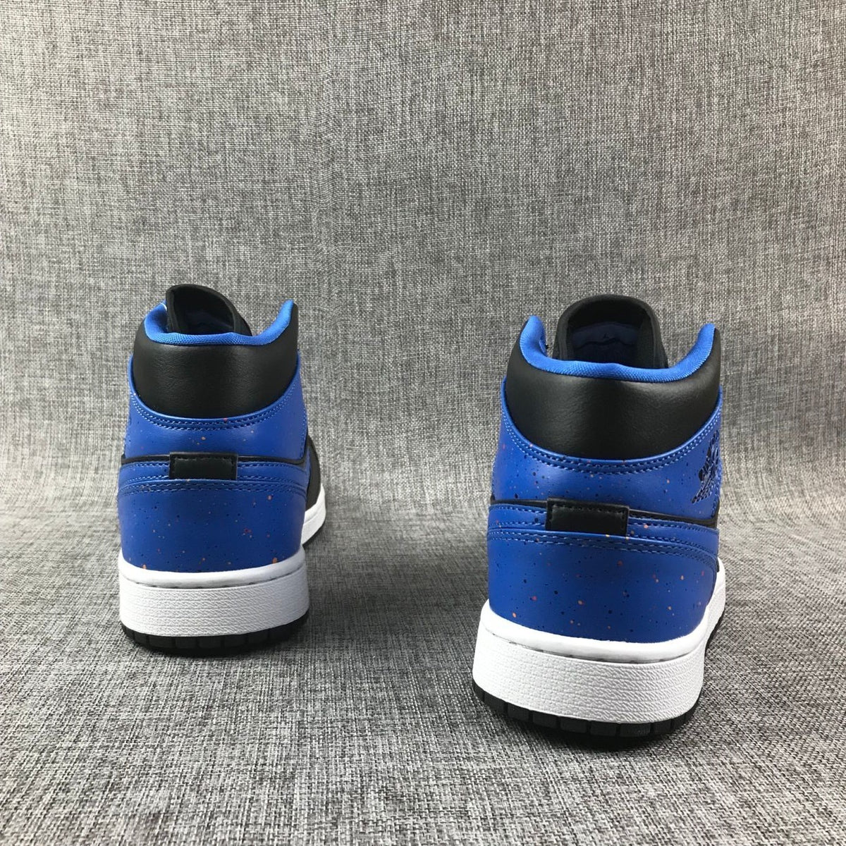 Rear view of the pair showing blue heel panels, black collars, and white midsoles.