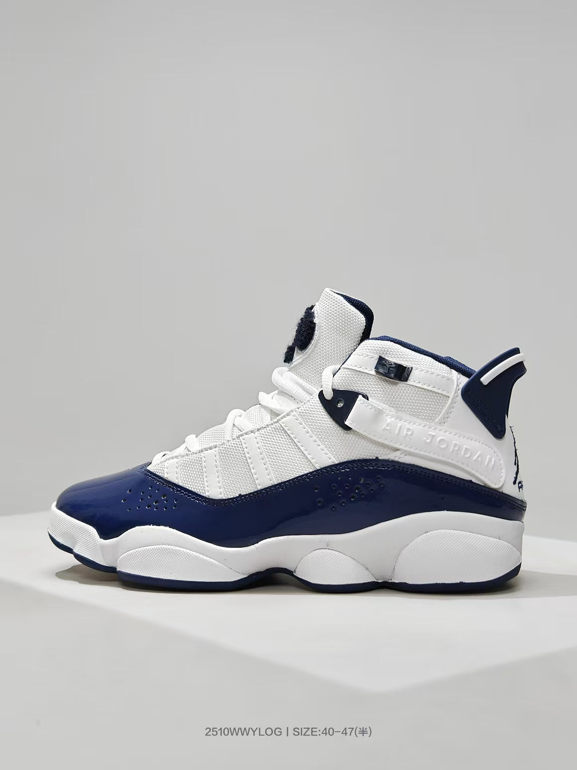 Close side view showing the white upper, navy overlays, perforations, and raised side branding.