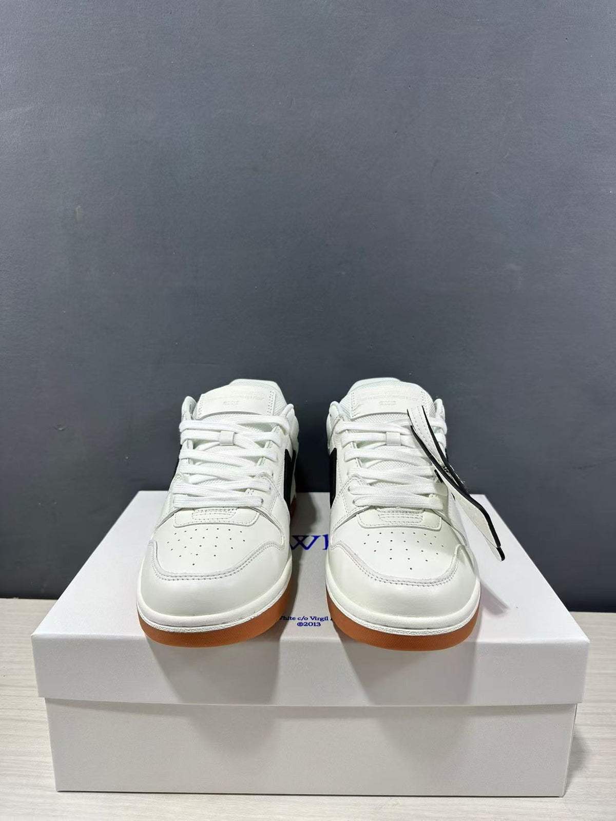 Front view of the pair showing white laces, rounded perforated toes, and gum outsole edges.