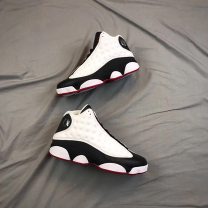 Pair of sneakers photographed on a gray background from a three-quarter angle.
