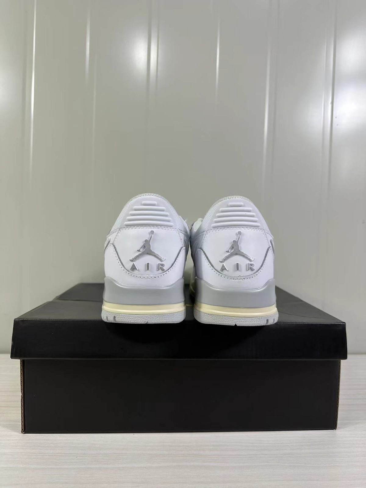Rear view showing Jordan branding, heel details, and light cream accents on the soles.