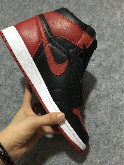 Handheld side view showing the red Swoosh, black quarter panel, red collar, and high-top construction.