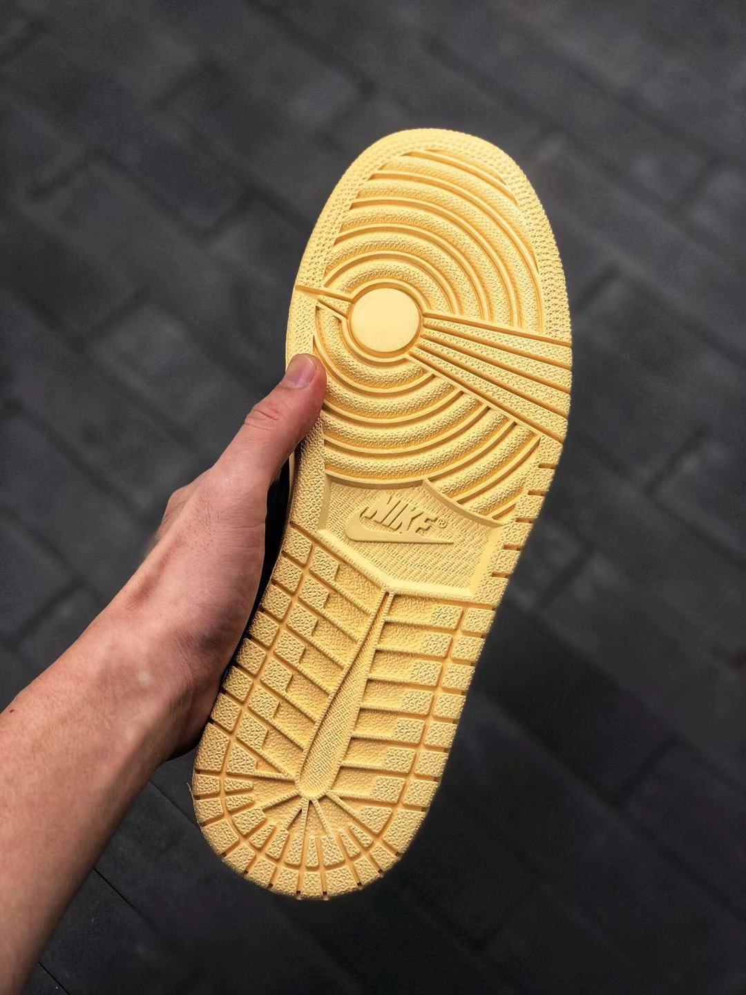 Close-up of the cream-colored outsole showing its circular traction pattern and embossed branding.