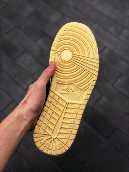 Close-up of the cream-colored outsole showing its circular traction pattern and embossed branding.