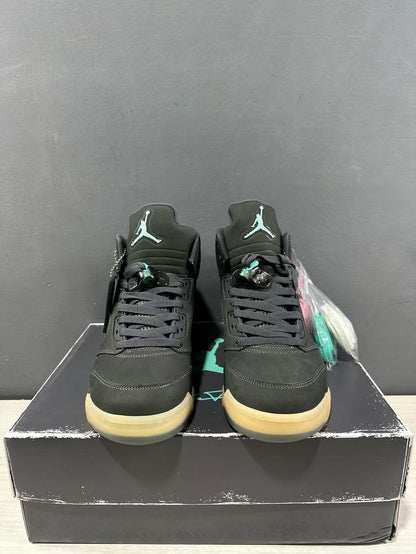 Front view of the Jordan Air Jordan 5 pair showing the tongue branding, black laces, dark green uppers, and translucent outsoles.