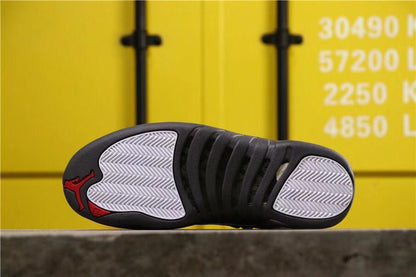 Outsole view showing dark rubber sections, light herringbone traction panels and red Jumpman details.