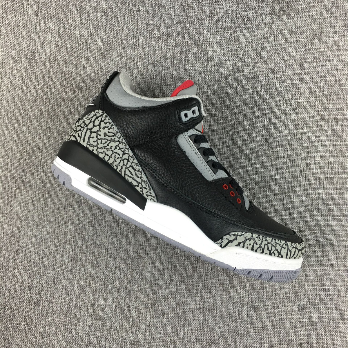 Outsole view showing grey tread and red traction detail