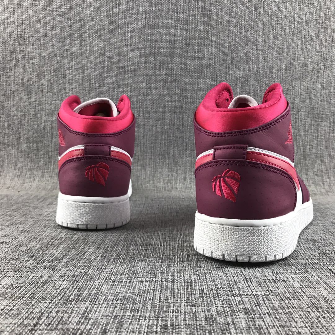 Rear view of both sneakers with pink collars and burgundy heel panels.