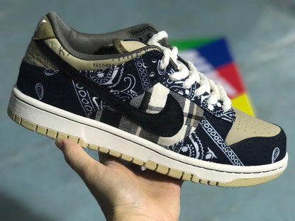Three-quarter product view showing the black patterned upper, plaid side panel, dark Swoosh, light laces, and beige toe box.