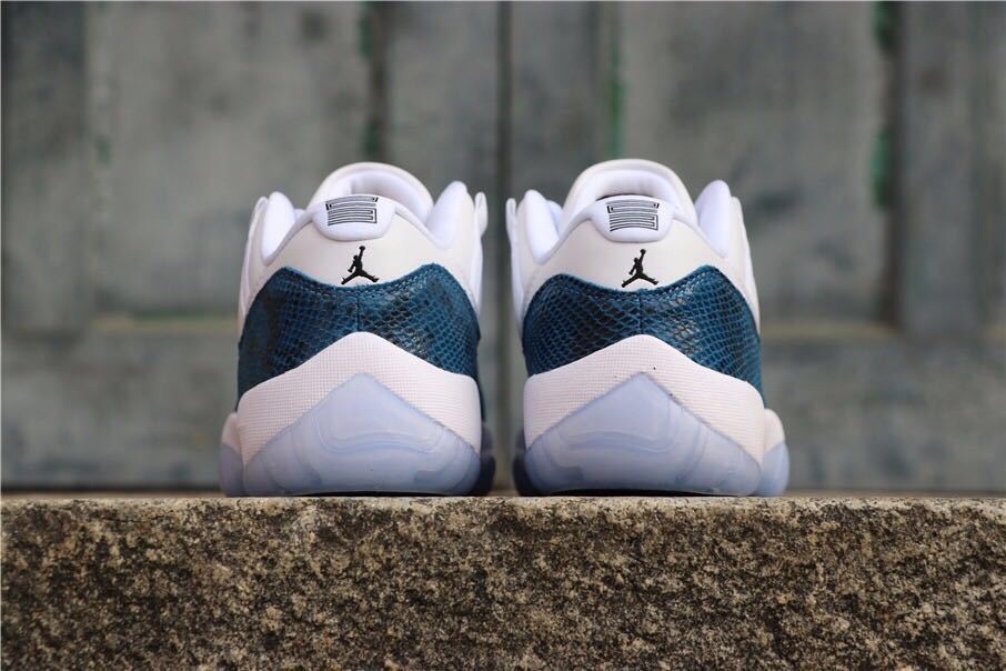 Rear view of the pair showing navy heel panels, white midsoles, and translucent outsoles.