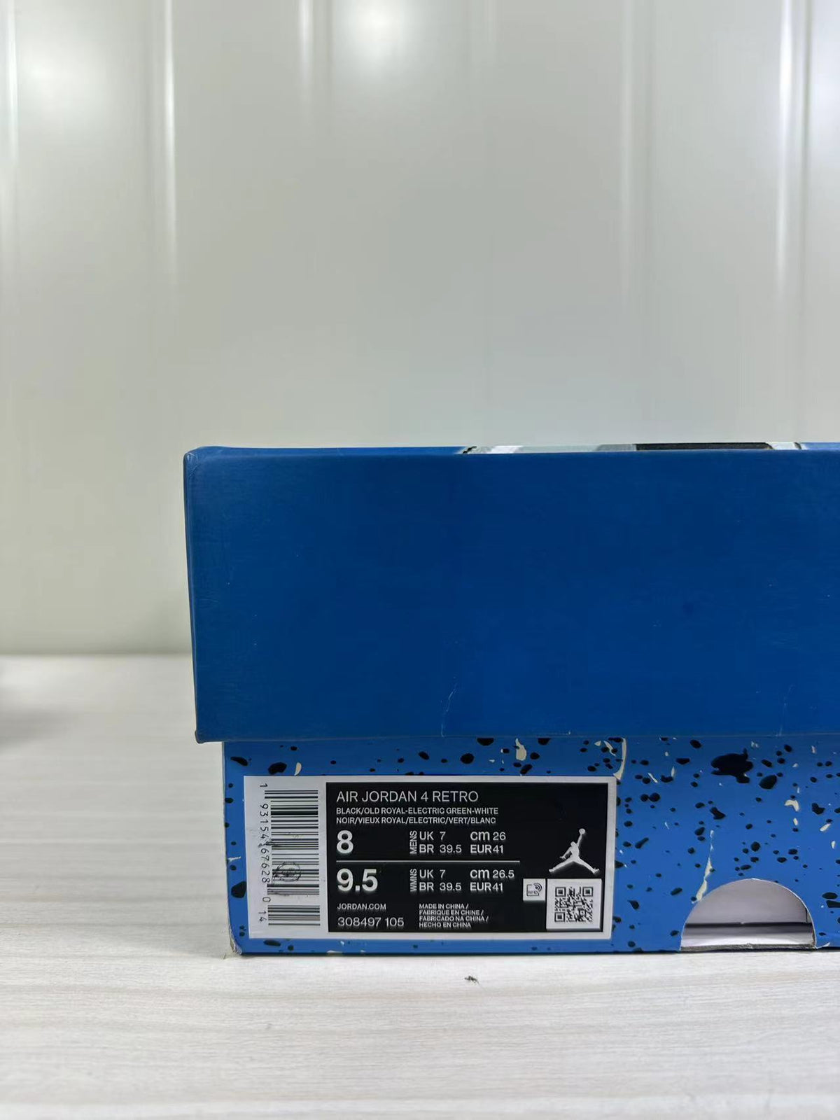 Blue shoebox with a visible Air Jordan 4 Retro label showing style code 308497-105 and a photographed EU 41 size.