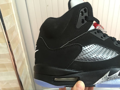 Close-up of the black upper, silver side panel, ankle padding, and visible outsole window.