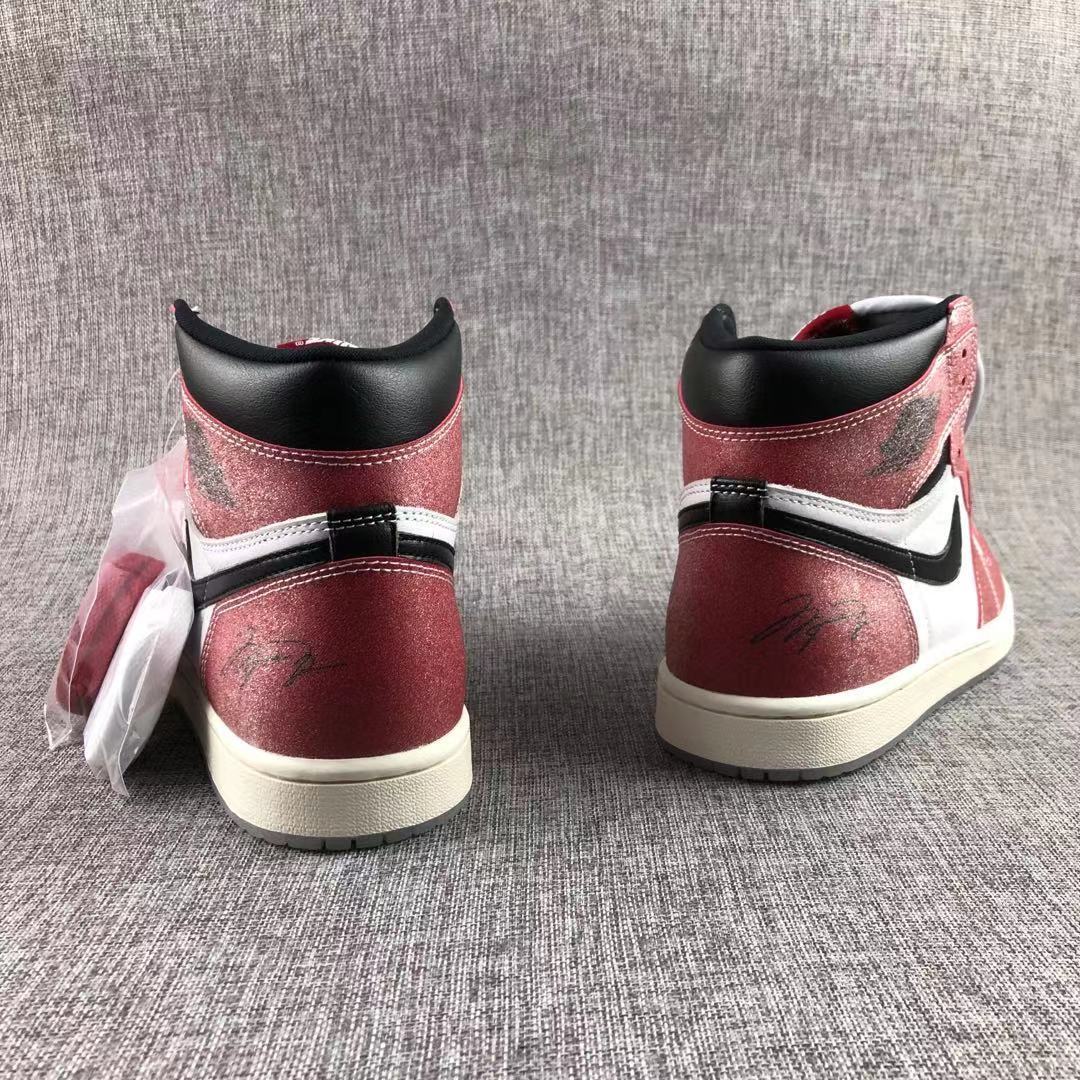 Rear view showing the red heel panels, black collars and white stitching.